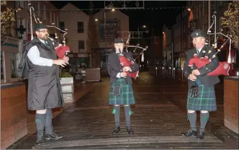  ??  ?? Pipers Johnnie Sheehan, Favstas Cesnavicus and Chris Boome marked the centenary of Amristice Day by playing retreat march ‘the Battle’s O’er’ at 6am on the Mall in Tralee.