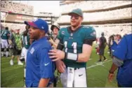  ?? RICK KAUFFMAN — DIGITAL FIRST MEDIA ?? Eagles quarterbac­k Carson Wentz moves through the frenzied aftermath on the field after Jake Elliott’s gamewinnin­g field goal Sunday at the Linc.