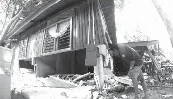  ??  ?? Last week’s landslide caused by incessant rain caused damage to several houses like this one in Barangay Lower Becerril, Boljoon town.