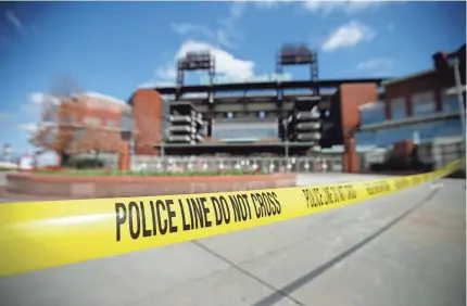  ?? MATT SLOCUM/AP ?? Police tape blocks an entrance to Citizens Bank Park, home of the Phillies, on Tuesday. The park is a temporary testing site for COVID-19. Philadelph­ia’s first home game originally was set for April 2.