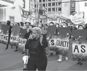  ??  ?? Hana Abdur-rahim leads a group down North Front Street during the “Stop the Lies” protest Wednesday evening in Columbus.