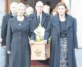  ?? PHOTO: FRANK MCGRATH ?? Mourning: Richie Ryan’s daughters Aoife and Bláthnaid and son Declan accompany the coffin.