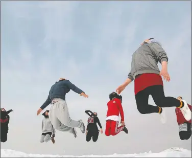  ??  ?? Afghan girl members of a jiujitsu club jump during a practice session on a hilltop in Kabu.