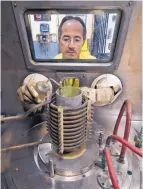  ?? SOURCE: LOS ALAMOS NATIONAL LABORATORY ?? Production of plutonium triggers, or pits, for nuclear weapons is expected to resume at LANL, with a mandated goal of making 80 pits a year by 2030. Here, work on a pit is through an airtight glovebox.