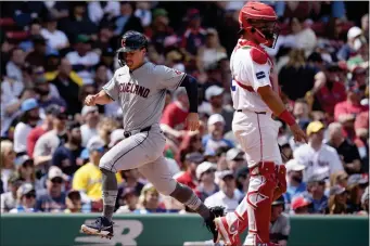  ?? MICHAEL DWYER — THE ASSOCIATED PRESS ?? Cleveland Guardians’ Will Brennan scores on an RBI double by Gabriel Arias behind Boston Red Sox catcher Reese McGuire during the ninth inning of a baseball game, Monday, April 15, 2024, in Boston.