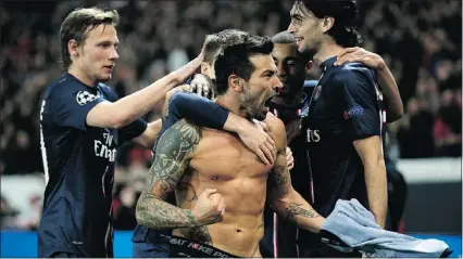  ?? — GETTY IMAGES ?? Ezequiel Lavezzi of Paris Saint-Germain takes off his shirt after he scored his team’s first goal in the UEFA Champions League match between PSG and Valencia CF on Wednesday in Paris.