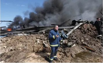  ?? (Aziz Taher/Reuters) ?? A CIVIL DEFENSE member stands at a site that was hit by an Israeli airstrike on Monday around 60 km. north of the border with Israel.