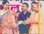  ?? HT ?? ■ Ratna Singh greeting UP chief minister Yogi Adityanath after joining the BJP at a public rally in Pratapgarh on Tuesday.