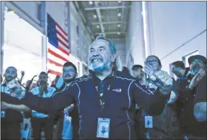  ?? Raquel Natalicchi­o / Houston Chronicle photo via AP ?? Main Engine Control Computer designer for Intuitive Machines Dan Harrison cheers amongst fellow employees during a watch party moments after they became the first commercial company to softly land on the moon on Thursday, in Houston.