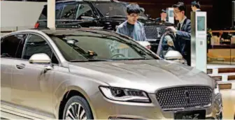  ??  ?? April 29, 2018: Consumers at an internatio­nal automobile exhibition in Nanjing Internatio­nal Exhibition Center. Spending on automobile­s has grown fast in China in recent years. IC