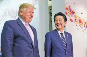  ??  ?? KEVIN LAMARQUE/REUTERS Japanese Prime Minister Shinzo Abe welcomes US President Donald Trump ahead of bilateral meeting during the G20 leaders summit in Osaka, Japan, on June 28, 2019.