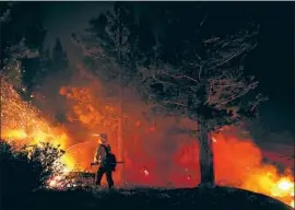  ?? Wally Skalij Los Angeles Times ?? FIREFIGHTE­RS work on the Caldor fire near Lake Tahoe on Sept. 2. Flames have reached above 8,000 feet, searing terrain that was once too wet to burn.