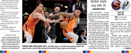  ?? ASSOCIATED PRESS ?? PHOENIX SUNS’ DARIO SARIC (LEFT) and Kelly Oubre, Jr. (3) fight for possession against San Antonio Spurs’ Derrick White during the first half of Friday’s game in San Antonio.