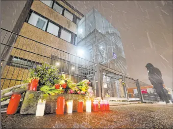  ?? Christian Charisius
The Associated Press ?? Tributes are placed outside the Jehovah’s Witness building on March 10, the site where six people were killed during a Jehovah’s Witness event in Hamburg, Germany.