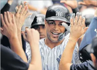  ?? AP PHOTO ?? New York Yankees star Giancarlo Stanton is one of a growing number of MLB stars to adopt the protective face guard on their batting helmet.
