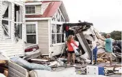  ?? JULIA WALL Raleigh News & Observer via TNS ?? Residents in Emerald Isle, N.C., assess the damage Thursday after Hurricane Dorian caused a tornado.