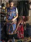  ??  ?? Kyle Todd (left) getting dressed for his initiation ceremony to become a Sangoma or traditiona­l healer.