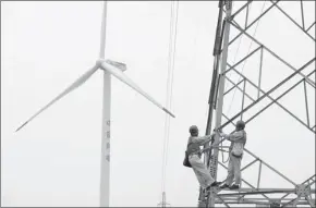  ?? SONG WEIXING / FOR CHINA DAILY ?? Technician­s check wind power facilities in Tianchang, Anhui province.