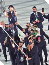  ??  ?? La delegación argeliana a su ingreso al estadio olímpico en la inauguraci­ón.