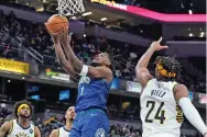  ?? DARRON CUMMINGS/ASSOCIATED PRESS ?? The Timberwolv­es’ Anthony Edwards, left, shoots against the Pacers’ Buddy Hield during the first half of Sunday’s game in Indianapol­is.