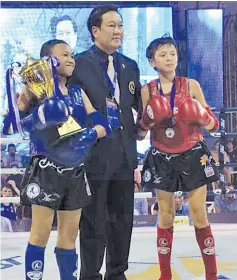  ??  ?? WORLD YOUTH CHAMPION: Daniel (left) with the trophy after his victory in the 12-13 years old 42kg division final in the 2017 IFMA Youth World Championsh­ips in Bangkok, Thailand.
