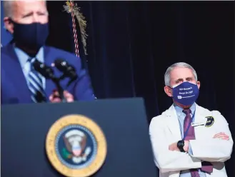  ?? Saul Loeb / AFP via Getty Images ?? President Joe Biden speaks on Feb. 11, flanked by White House Chief Medical Adviser on COVOD-19 Dr. Anthony Fauci, during a visit to the National Institutes of Health in Bethesda, Md. The United States was on the brink Sunday of the grim milestone of 500,000 COVID-related deaths since the start of the pandemic, as the nation's top virus expert warned a form of normalcy may not return until the end of the year.