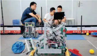  ??  ?? August 26, 2018: Two kids write code to make their robots move, in Hangzhou. Lego’s high-speed growth in China in recent years can be largely attributed to its non-traditiona­l businesses such as Lego Education. IC