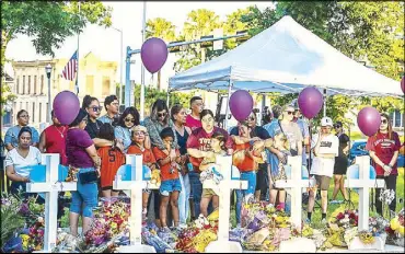  ?? AFP ?? Soccer teammates of Tess Mata, who died in the shooting, cry as they visit a makeshift memorial outside the Uvalde county courthouse in Texas on Thursday.