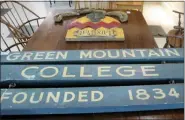  ?? AP PHOTO/LISA RATHKE ?? A Green Mountain College sign is on display among the goods to be sold at an auction at the school in Poultney, Vt. The school closed in May and now the town that hosted it for 185 years is awaiting to hear what will become of the campus.