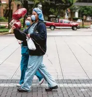  ??  ?? Registered nurse Margaret Padernal, left, and respirator­y therapist Rena Boutte carry balloons.