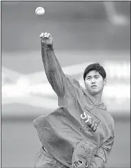  ?? AP/BEN MARGOT ?? Shohei Ohtani of the Los Angeles Angels throws during a spring training workout Tuesday in Tempe, Ariz. The 23-year-old Japanese standout, who signed with the Angels two months ago, is getting looks both as a pitcher and as an outfielder.