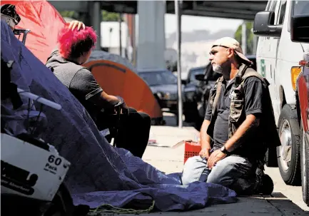  ?? Photos by Brant Ward / The Chronicle ?? Jason Albertson of the city’s Homeless Outreach Team talks about getting help for a woman camped on the street.