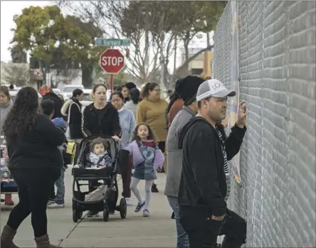  ?? Myung J. Chun Los Angeles Times ?? PARENTS at a Gardena school wait for their children. A three-day strike by school workers and teachers is set to start Tuesday.