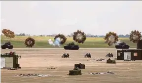  ?? REUTERS PIC ?? Tanks firing smoke bombs during the military drill simulating the China’s People’s Liberation Army invading the island at Ching Chuan Kang Air Base, in Taichung, Taiwan yesterday.