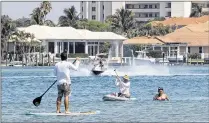  ??  ?? Paddleboar­ders, kayakers, swimmers and snorkelers share the Intracoast­al north of the Jupiter lighthouse with boaters. “It’s a deeply congested area,” says Tequesta Mayor Abby Brennan.