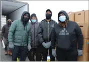  ?? LYRIC AQUINO — THE MORNING JOURNAL ?? Demond Nicholson, 42, Cleveland Browns star Kareem Hunt Jr., 25, Kareem Hunt Sr., 49, Jemall Hooks 28, and Ahmad Mungin, 24, spent the evening of Feb. 18 distributi­ng food to those in need with Second Harvest Food Bank of North Central Ohio.