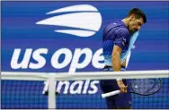  ?? ELISE AMENDOLA - THE ASSOCIATED PRESS ?? Novak Djokovic, of Serbia, wipes sweat from his face between serves from Daniil Medvedev, of Russia, during the men’s singles final of the US Open tennis championsh­ips, Sunday, Sept. 12, 2021, in New York.