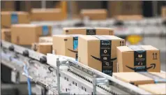  ?? Tribune News Service ?? Packages pass down a conveyor belt at an Amazon facility in Shakopee, Minn.