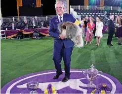  ??  ?? David Fitzpatric­k with his Pekingese ‘Wasabi’ are seen after winning Best in Show at the 145th Annual Westminste­r Kennel Club Dog Show at the Lyndhurst Estate in Tarrytown, New York. — AFP photos