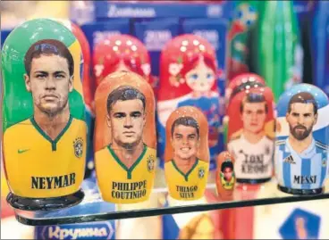  ?? GETTY IMAGES ?? Russian dolls featuring faces of Neymar, Philippe Coutinho, Thiago Silva and Lionel Messi for sale at a Moscow souvenir shop.