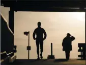  ?? THE ASSOCIATED PRESS ?? In this file photo people are silhouette­d against an autumn sky walk along the Schuylkill Banks Boardwalk in Philadelph­ia. A key benefit of a Roth 401K?