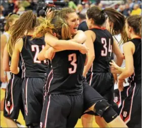  ?? AUSTIN HERTZOG - DIGITAL FIRST MEDIA ?? Lindsay Hillegas (41) celebrates with teammate Katie Armstrong (3) after Boyertown defeated North Allegheny to win the PIAA 6A girls basketball championsh­ip Friday in Hershey.