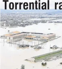  ?? PHOTOS: REUTERS ?? Under water . . . A broken river bank floods the surroundin­g area after extraordin­ary rainfall in Kurashiki, Okayama Prefecture, Japan, yesterday.