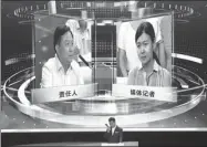  ?? JIN ZHENQIANG / FOR CHINA DAILY ?? An official is questioned about his work by a reporter during the live television program in Wuhan, Hubei province, on Tuesday night.