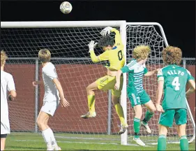  ?? KYLE TELECHAN / POST-TRIBUNE ?? Chesterton goalkeeper Charlie Eaton leaps to clear a ball from his goal against Valparaiso during a Class 3A Crown Point Sectional semifinal on Wednesday.