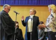  ?? PETE BANNAN — DIGITAL FIRST MEDIA ?? Chester County Treasurer Patricia Maisano is sworn in by her husband, Judge Daniel Maisano at ceremonies held at West Chester University Sykes ballroom Wednesday. Holding the Bible is her sister-in-law, Stephanie Johnston.