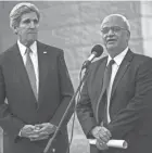  ?? BRENDAN SMIALOWSKI/AP ?? U.S. Secretary of State John Kerry, left, listens to Palestinia­n negotiator Saeb Erekat make a statement to the press after a meeting.