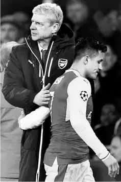  ??  ?? Sanchez (right) walks past manager Arsene Wenger as he is substitute­d during the UEFA Champions League round of 16 second leg match between Arsenal v Bayern Munich at Emirates Stadium in London, England in this March 7, 2017 file photo. — Reuters photo