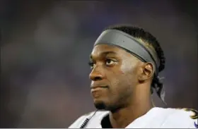  ?? NICK WASS — THE ASSOCIATED PRESS ?? Baltimore Ravens’ quarterbac­k Robert Griffin III looks on from the sideline during a preseason game against the Washington Redskins last week. Griffin, the 2012 NFL Offensive Rookie of the Year, remained with Baltimore as the Ravens cut their roster to the league maximum of 53 on Saturday.