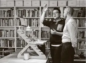  ?? Jessie Wardarski / Associated Press ?? Casper ter Kuile, left, and his husband, Sean Lair, teach the song “Hinei Ma Tov” to a virtual community choir from their living room in Brooklyn last weekend.